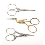 Three pairs of 19th Century steel scissors comprising a folding safety pair with spring catch,