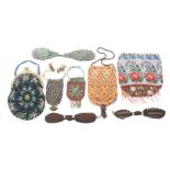 A collection of beadwork and other purses comprising three knitted purses, two with metal