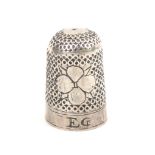A 17th Century English silver thimble the body with two four leaf clover or rose motifs, the plane