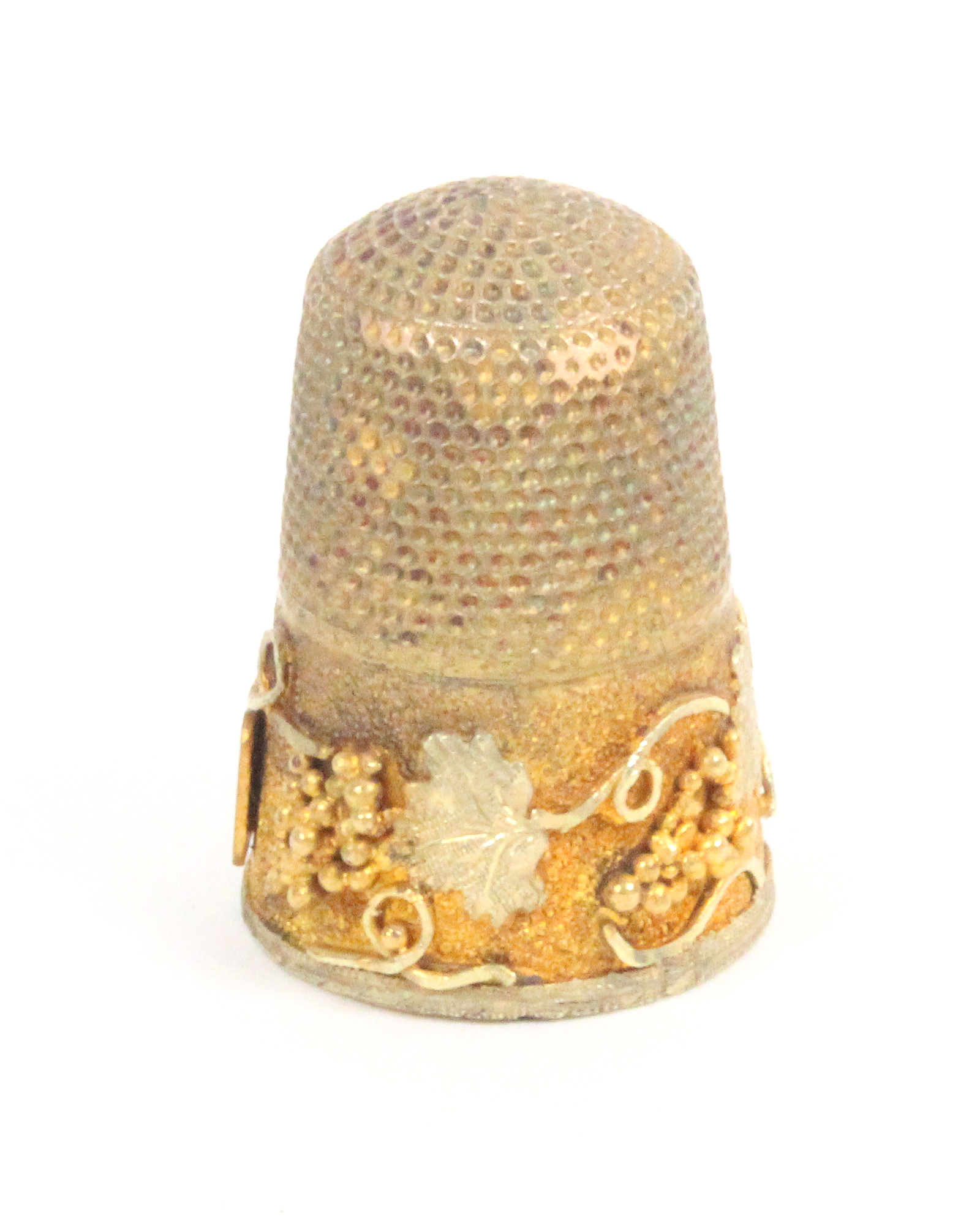 A gold thimble the two colour gold frieze with a raised design of a fruiting vine with vacant plaque