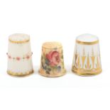 Three English porcelain thimbles comprising a Worcester example with a band of raised red dots