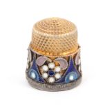 A Russian silver gilt and cloissone enamel thimble, with a deep frieze of flower heads and other