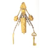 A good early 19th Century gilded metal chatelaine the clip with a scroll mount enclosing figures