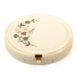 A 19th Century continental ivory etui, of oval form, the hinged lid decorated with a flowering