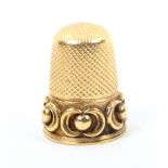 A 19th Century gold thimble the frosted frieze with raised dots within ïCÍ scrolls (From the