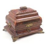 A Regency red leather covered sewing box of sarcophagal form with gilt tooled borders, gilt brass