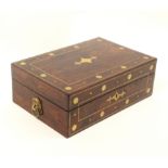 A late Regency rosewood sewing box of rectangular form, the lid and front inlaid with cut brass