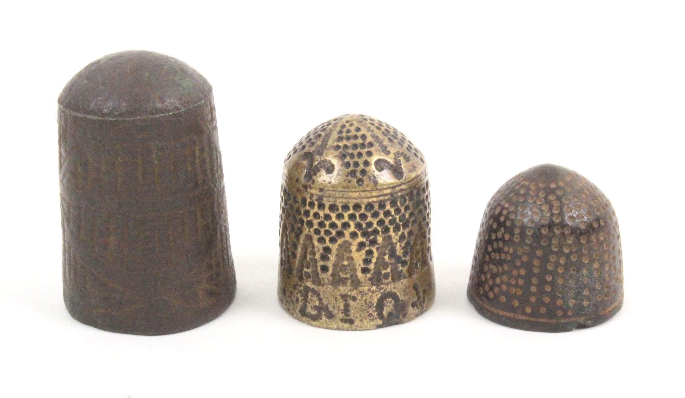 An 17th Century English metal thimble the scratch trellis ground with strapwork style decoration,