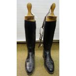 A pair of Gentleman's black Hunting Boots with wooden trees, boot pulls and spurs.
