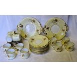 A Victorian Teaset decorated with floral garlands on a cream ground, comprising twelve cups and