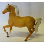 A Beswick model of a prancing Arab type Horse in matt Palomino finish, No. 1261.