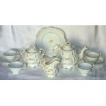 A Victorian Teaset decorated with gilt scrolls etc. comprising twelve ribbed cups, on a pedestal