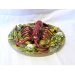 A Continental Palissy style Dish decorated with a lobster and other shell fish. 11" (28cms)