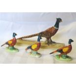 A Beswick model of a Pheasant on a ceramic base, no. 1774, a pheasant ornament, no. 767a and two