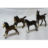 A Beswick Model of a brown foal, no.1816, first version and three other brown Beswick foals.