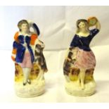 A pair of 19th Century Staffordshire pottery standing figures, each with a dog. 7" (17cms) high.