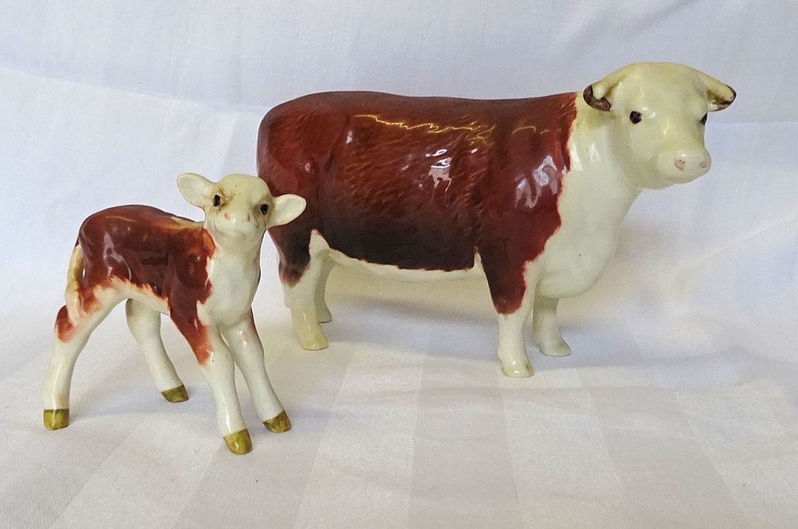 A Beswick model of a Hereford Cow, no. 1360 and a Hereford calf no. 1406b.