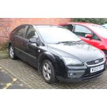 A black Ford Focus Climate, 06, 1.6,  petrol, mile