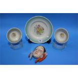 A decorative porcelain wall mask and four pieces o