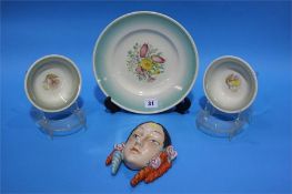 A decorative porcelain wall mask and four pieces o