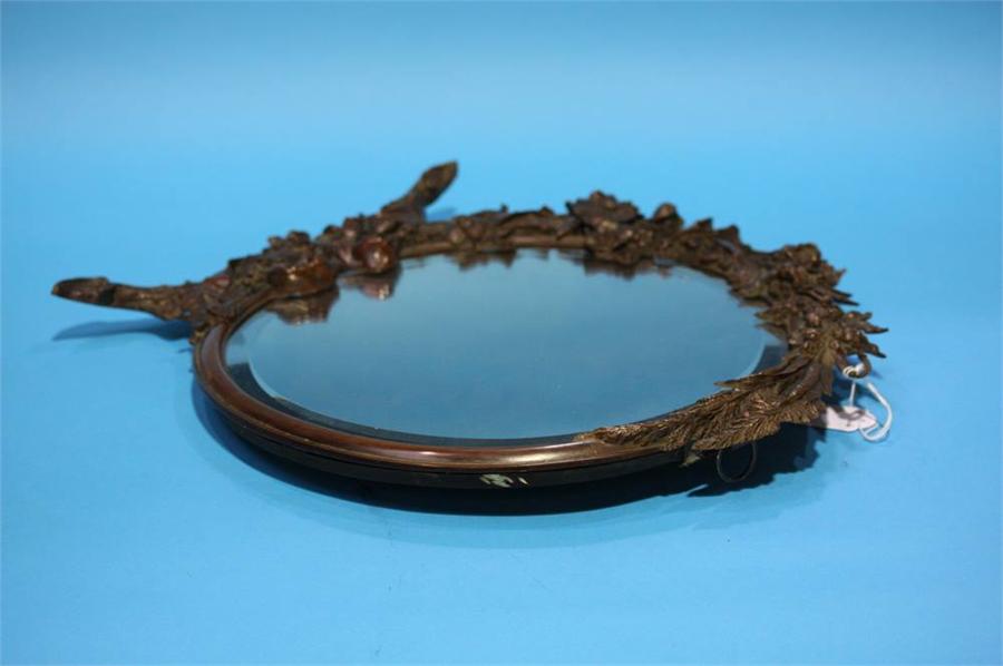 A Bronze decorative circular mirror.
