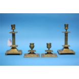 Two pairs of brass candlesticks.