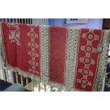 A Crochet work red and white panelled table cloth.