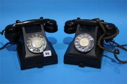 Two Bakelite telephones.