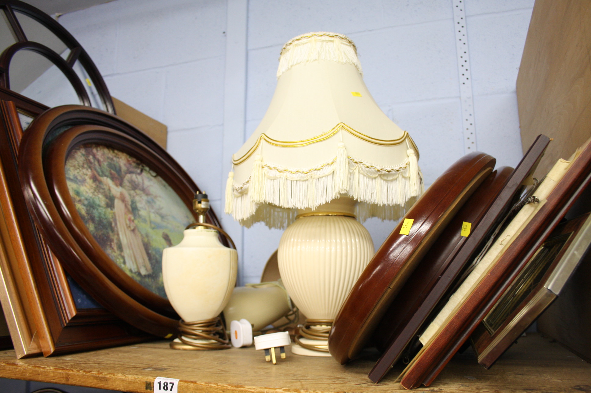 Shelf of pictures and a pair of lamps