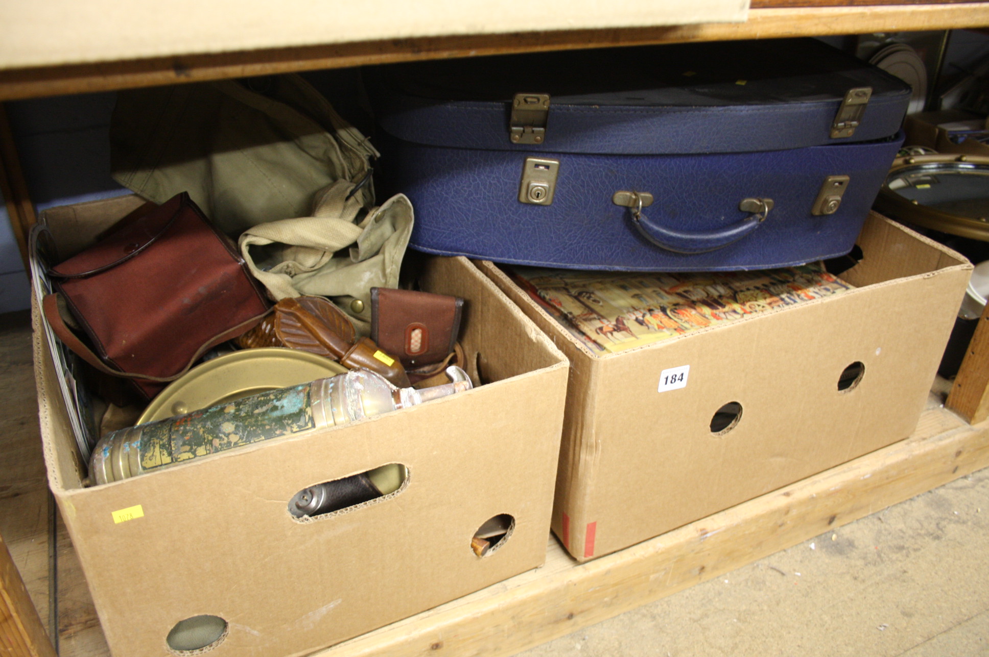 Shelf of assorted, ephemera, brass, wooden items etc.