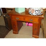 A mahogany pedestal desk and a coal scuttle.