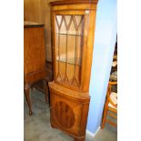 A yew wood corner cabinet.