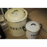 An enamel bread bin and a flour bin.