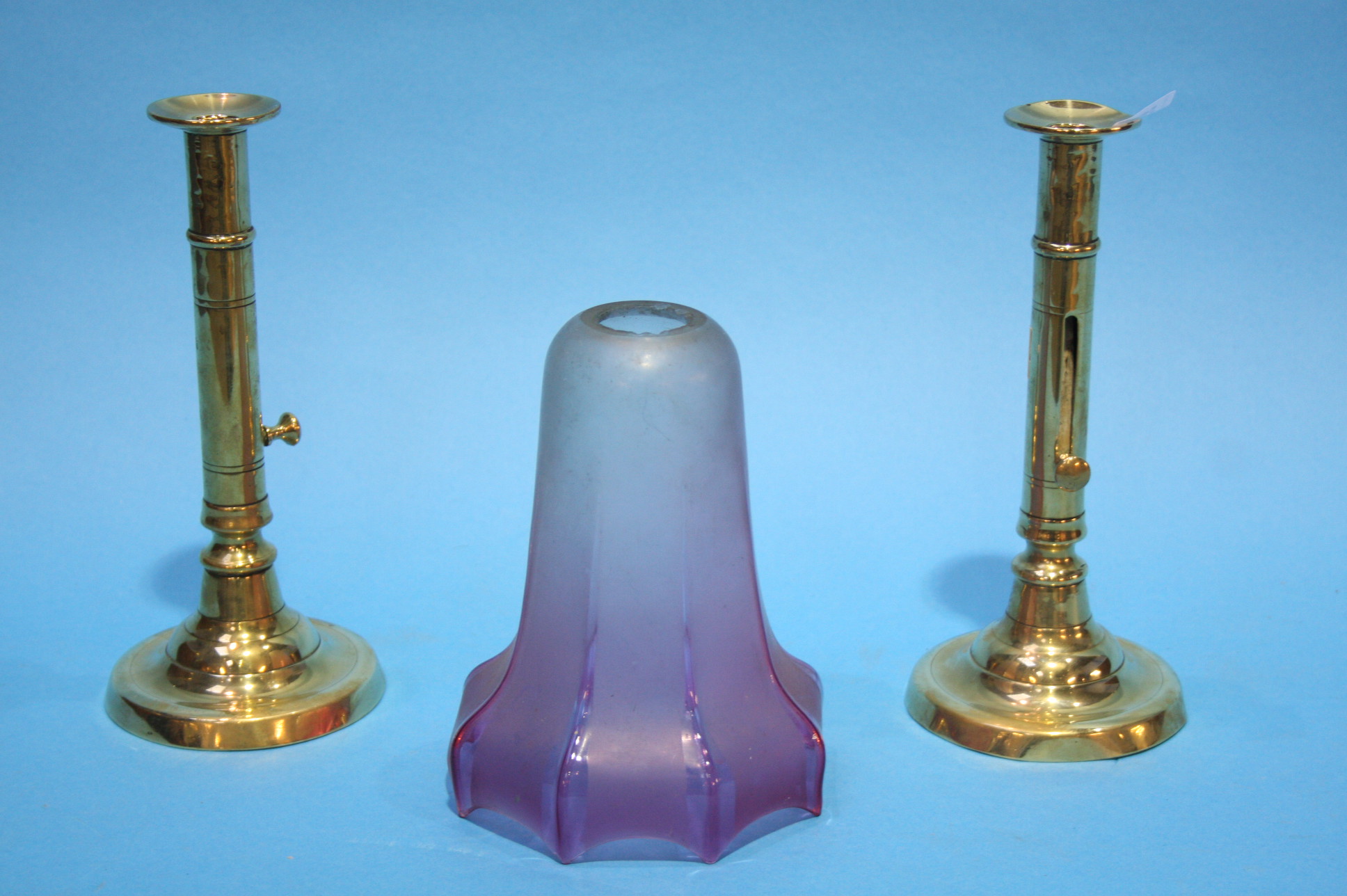 A pair of brass candlesticks and a Cranberry frost