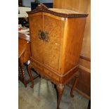 A walnut Queen Anne style cocktail cabinet.