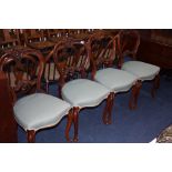 A set of four Victorian walnut dining chairs.