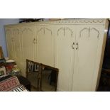 Three cream double door wardrobes.