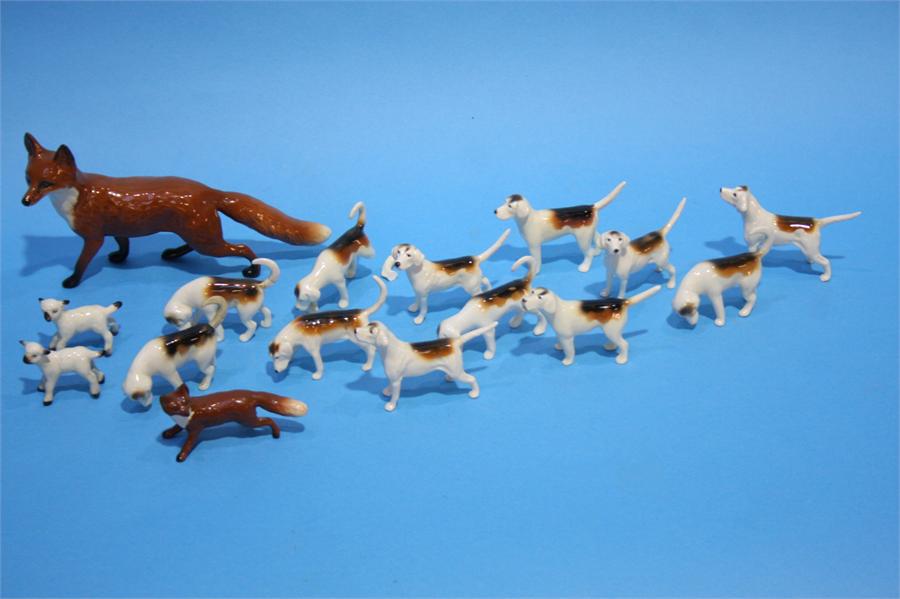 Two Beswick foxes and a collection of Hunting dogs