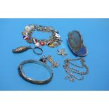 A silver bracelet, locket etc.