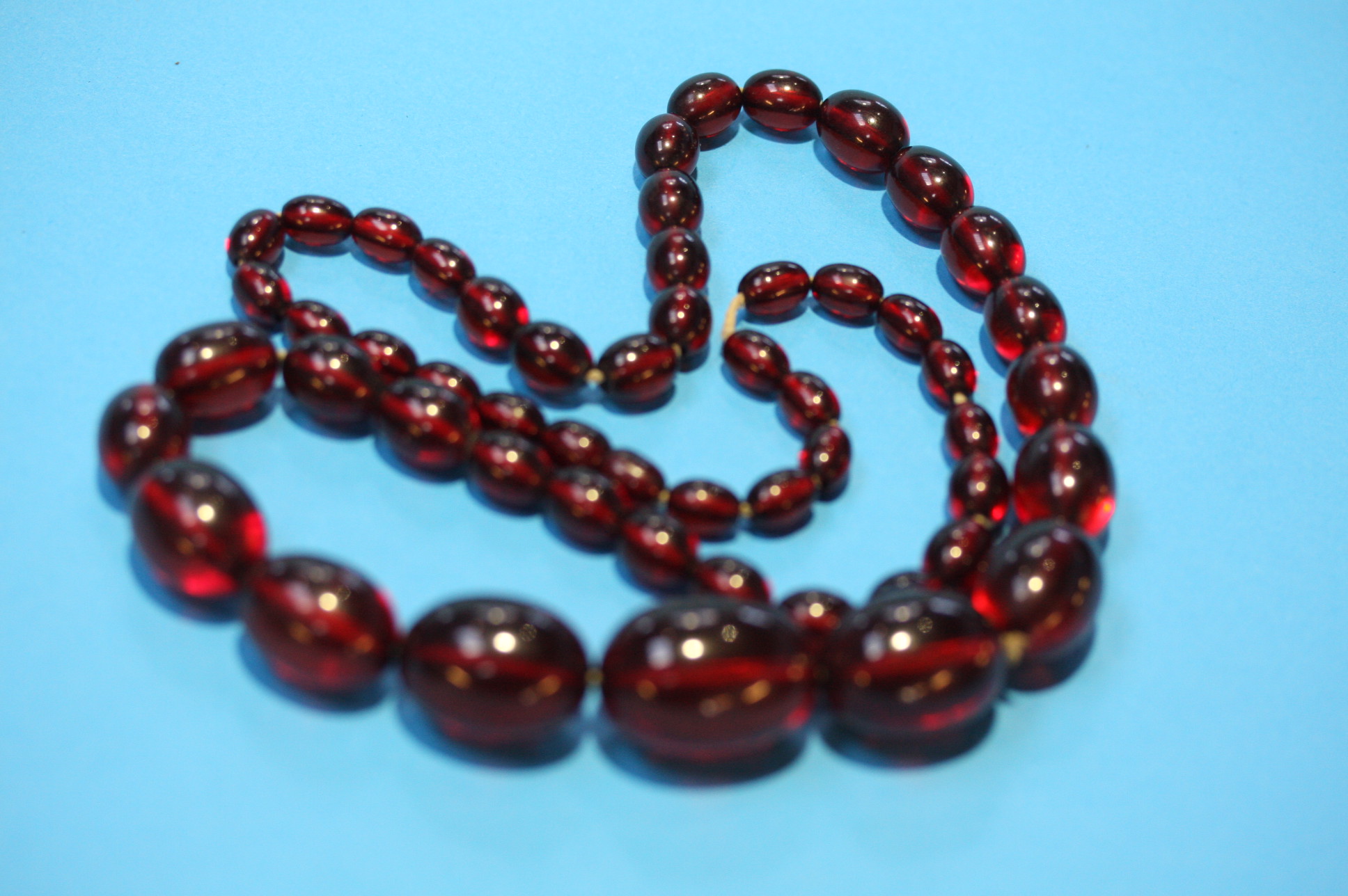 A string of cherry amber coloured beads.