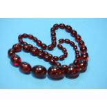 A string of cherry amber coloured beads.