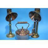 Two brass lamps and a copper kettle.