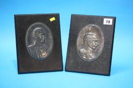 A pair of German oval metalware relief plaques, depicting German military