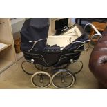 A silver cross pram