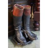 Pair of riding boots and boot scraper