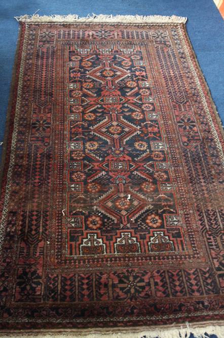 A modern Afghan rug, with triple central medallion, multiple guard stripes and main floral geometric