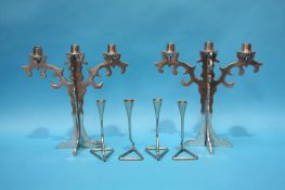 A set of four Chrome candlesticks and a pair of aluminium 3 sconce candelabra