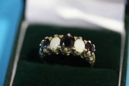 A Victorian 9ct gold opal and garnet set ring