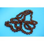 A long string of amber coloured beads