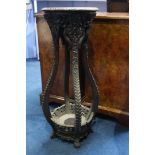 An Oriental Hardwood pedestal inset with marble